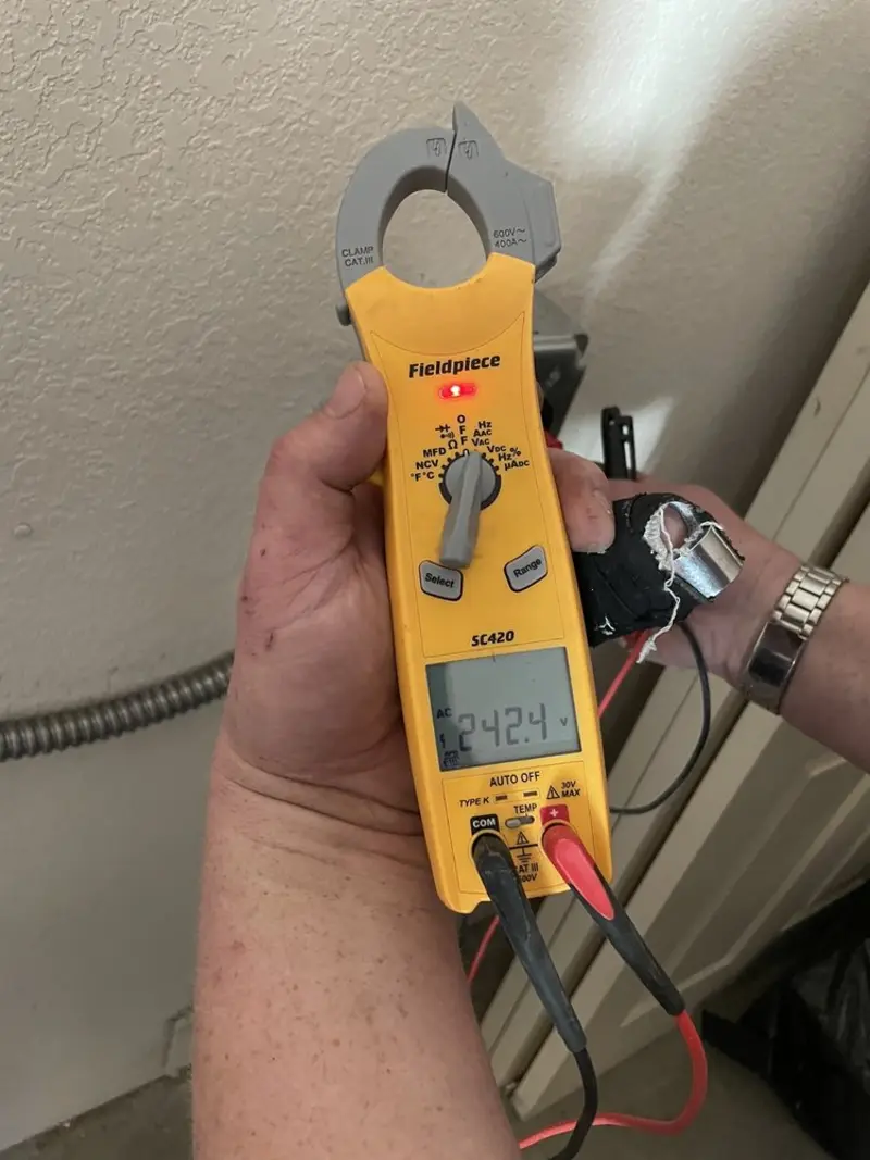 Voltage testing with clamp meter during Whole House Surge Protector in Economy